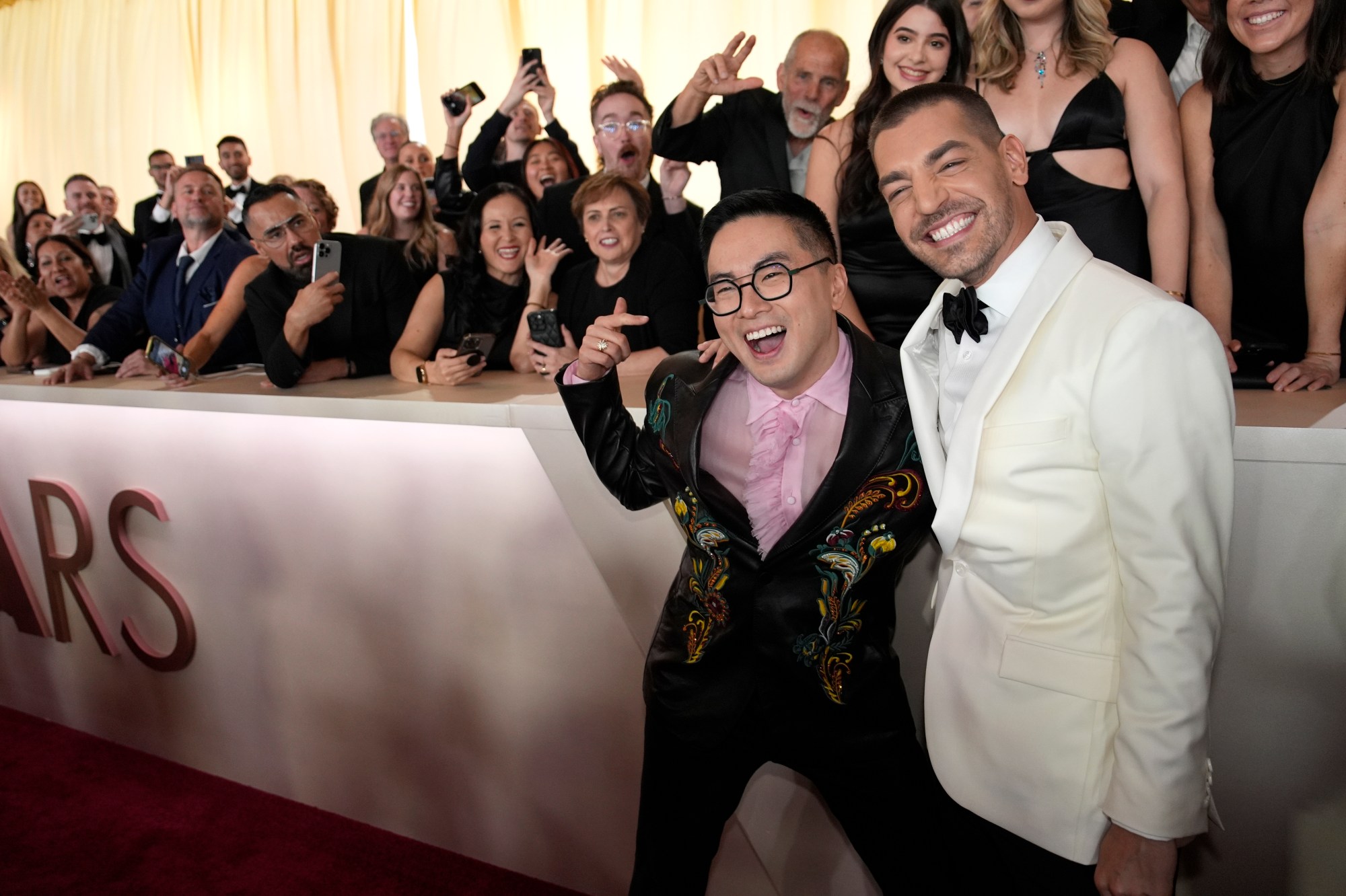 Bowen Yang, left, and Matt Rogers arrive at the Oscars on Sunday, March 2, 2025, at the Dolby Theatre in Los Angeles. (AP Photo/John Locher)