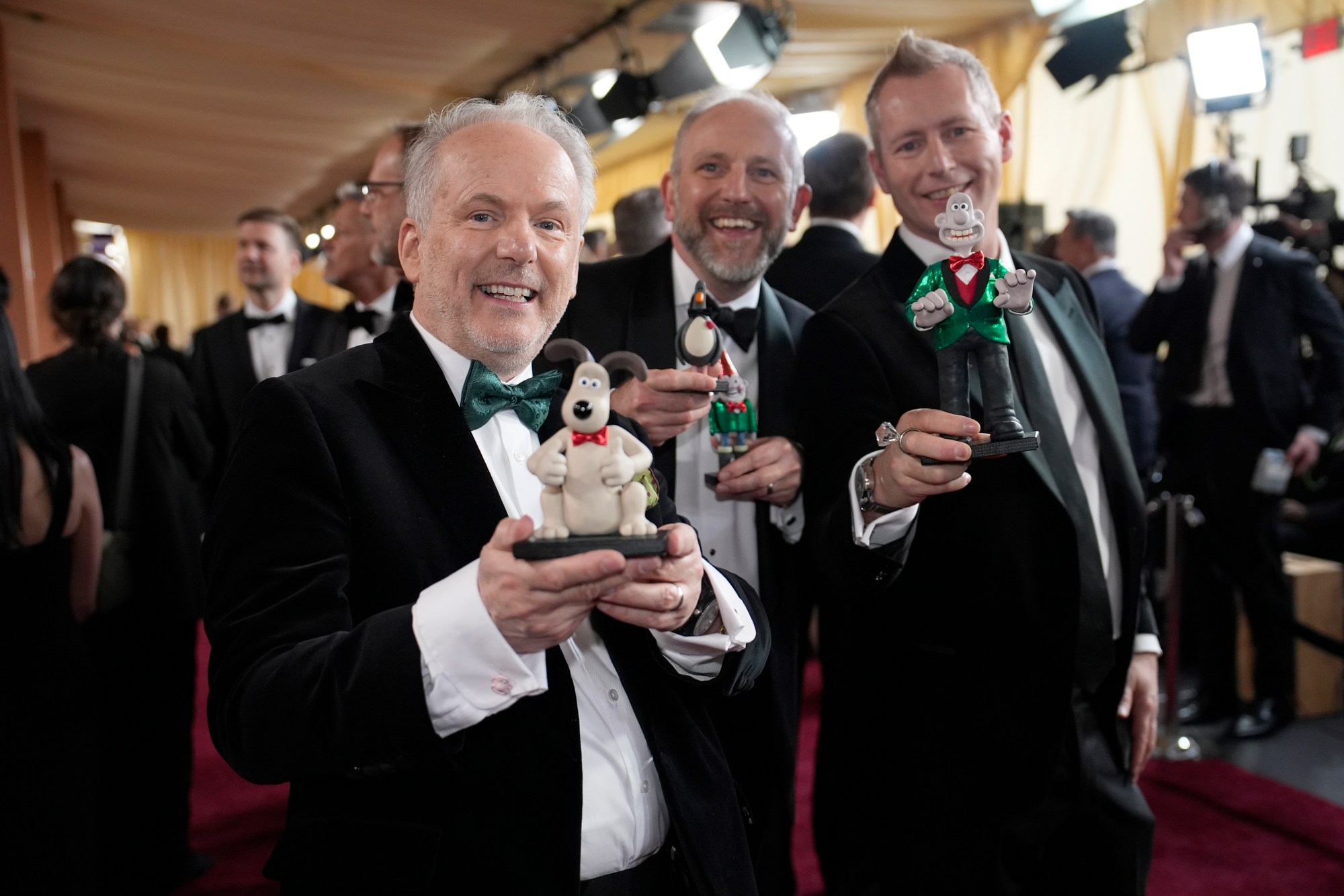 Nick Park, from left, Richard Beek and Merlin Crossingham arrive at the Oscars on Sunday, March 2, 2025, at the Dolby Theatre in Los Angeles. (AP Photo/John Locher)