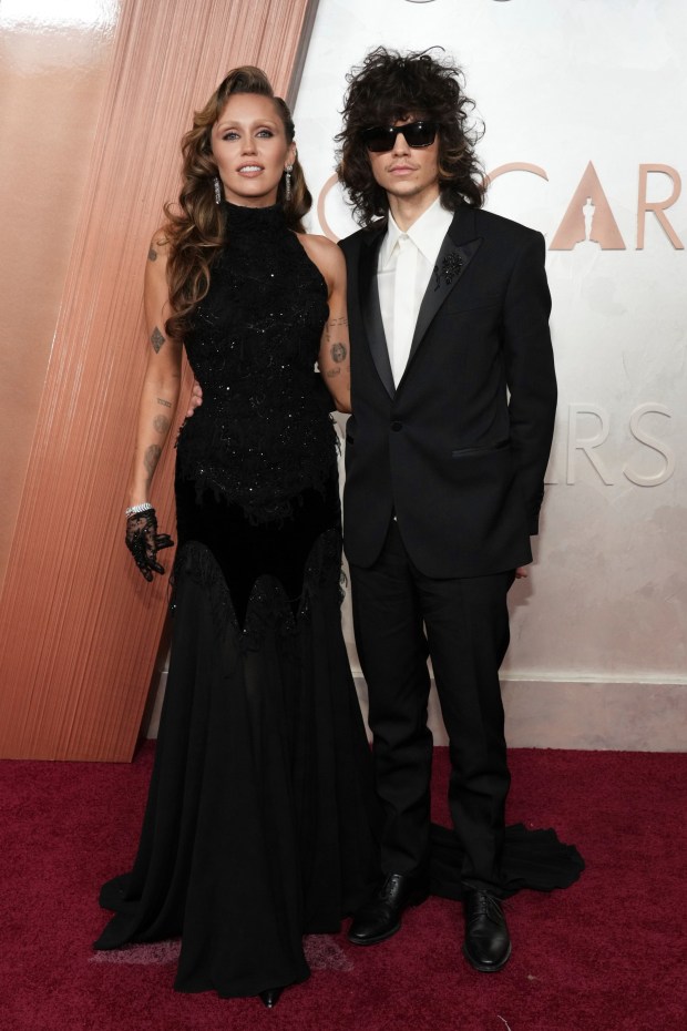 Miley Cyrus and Maxx Morando arrive at the Oscars