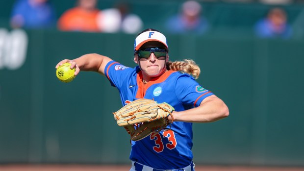 Florida outfielder Korbe Otis (33) warms up before an NCAA regional softball game against Mercer, Friday, May 16, 2025, in Gainesville, Fla. (AP Photo/Gary McCullough)