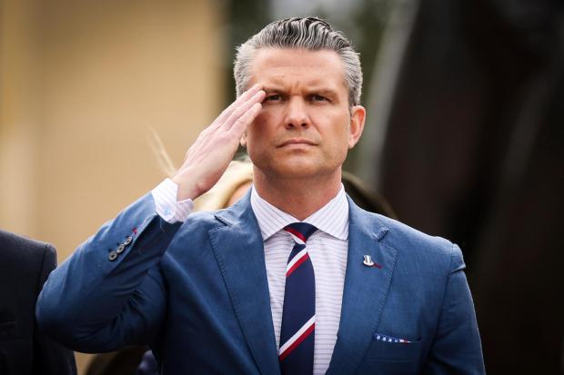 U.S. Defense Secretary Pete Hegseth salutes during a ceremony at the US cemetery to commemorate the 81st anniversary of the D-Day landings, Friday, June 6, 2025 in Colleville-sur-Mer, Normandy. (AP Photo/Thomas Padilla)