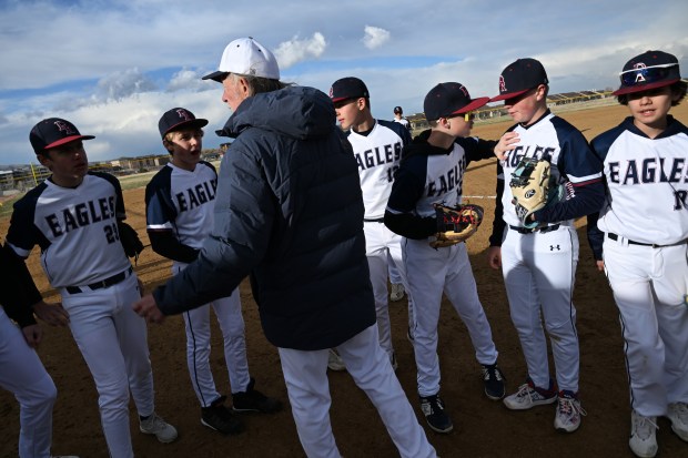 Rick Fisher, the pitching coach with Dakota Ridge's eighth grade feeder team, center, talks with the team in between innings during their game against Columbine at Easton Fields in Littleton, Colorado, on April 1, 2025. (Photo by Helen H. Richardson/The Denver Post)