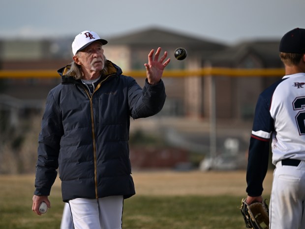 Dakota Ridge's eighth grade feeder team pitching coach, Rick Fisher, works with players between innings during a game against Columbine at Easton Fields in Littleton, Colorado, on April 1, 2025. (Photo by Helen H. Richardson/The Denver Post)