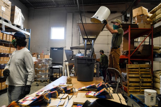 DENVER, CO - APRIL 15: Mike Tymoski pours coffee beans into a bagging sorter at Huckleberry Roasters on Tuesday, April 15, 2020. (Photo by AAron Ontiveroz/The Denver Post)