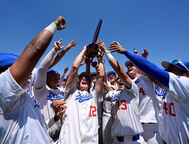 Cherry Creek's Wyatt Rudden (12) hoists the championship trophy after defeating the Regis Jesuit Raiders 8-1 in the Class 5A State Baseball Championship Game at All-Star Park in Lakewood, Colorado, on Saturday, May 31, 2025. (Photo by Andy Cross/The Denver Post)