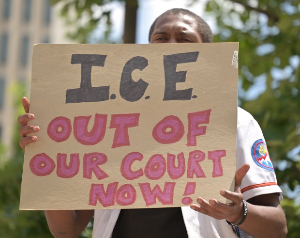 Abdulsalam, who declined to provide a last name, holds a sign during a press conference outside Denver Immigration Court on June 5, 2025. Local immigration advocacy groups organized the event to urge the community to help remove ICE from municipal, county, state, and federal courts. (Photo by RJ Sangosti/The Denver Post)