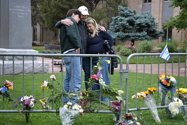 From left, Isaac Dechtman and his parents Evan and Jennifer comfort each other at the site of a makeshift memorial for victims of last Sunday's attack in front of the Boulder County Courthouse on Pearl Street in Boulder, Colorado, on Tuesday, June 3, 2025. (Photo by Hyoung Chang/The Denver Post)