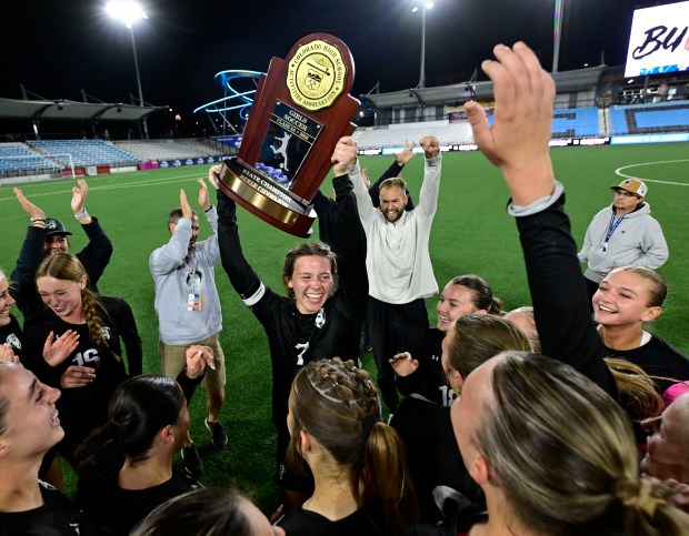 Teagan Myers (7) hoists the 5A championship trophy after defeating Castle View, winning the 5A state soccer championship game at Weidner Field in Colorado Springs, Colorado on Wednesday, May 21, 2025. Myers scored the winning goal, Fossil Ridge won 1-0. (Photo by Andy Cross/The Denver Post)