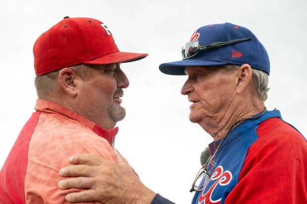 Regis Jesuit head coach Matt Darr, left, congratulates retiring Cherry Creek head coach Marc Johnson after Cherry Creek prevailed in their 5A double elimination state title games at All-Star Park in Lakewood on June 1, 2024. (Photo by Andy Colwell/Special to The Denver Post)
