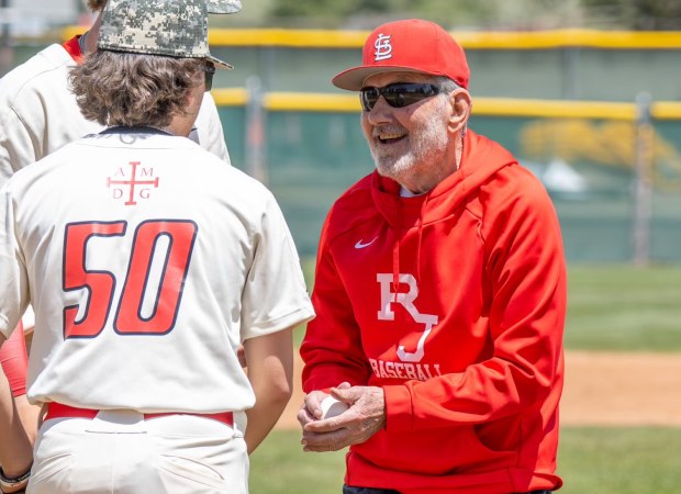 Loyal Darr, the father of Regis Jesuit head coach Matt Darr, smiles after throwing out the first pitch during a Raiders game in 2024. Darr passed away on March 7, 2025, at age 87. (Courtesy of Molly Hill/Regis Jesuit baseball)