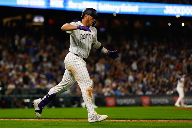 Hunter Goodman (15) of the Colorado Rockies celebrates his go-ahead grand slam in the eighth inning against the Chicago Cubs at Coors Field on Friday, Sept. 13, 2024, in Denver. (Justin Edmonds/Getty Images)