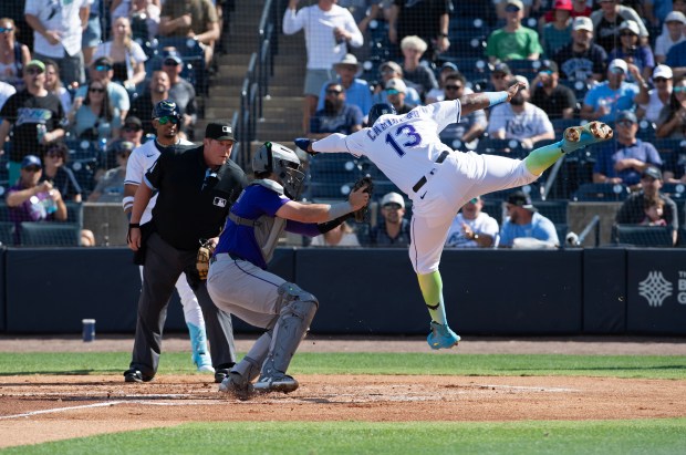 Colorado Rockies catcher Hunter Goodman, middle, applies the tag to the Tampa Bay Rays' Junior Caminero (13) during the second inning at George M. Steinbrenner Field on Saturday, March 29, 2025, in Tampa, Florida. (Mark Taylor/Getty Images)