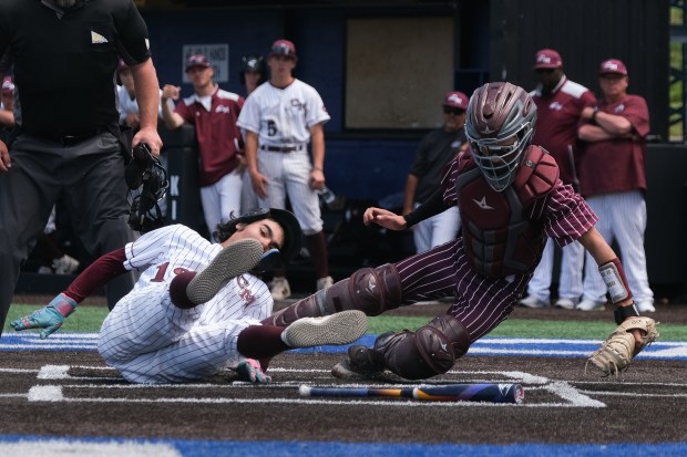 Cheyenne Mountain senior Noah Reickert (13) collides with Golden sophomore catcher Caycen Mead (17) as he's called out at home plate in the final CHSAA Class 4A Baseball State Championship Game at Erdle Field at the Air Force Academy in Colorado Springs, Colorado, on Saturday, May 31, 2025. (Eli Imadali/Special to The Denver Post)