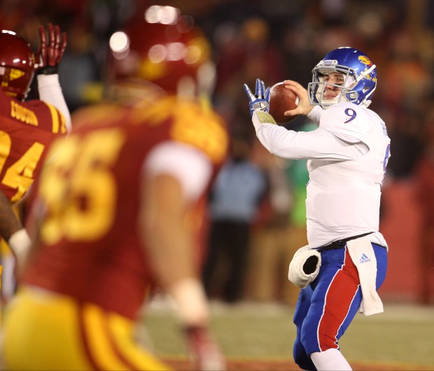 Kansas quarterback Jake Heaps (9) gets ready to throw a pass during the second half of an NCAA college football game against Iowa State in Ames, Iowa, Nov. 23, 2013. (AP Photo/Justin Hayworth)
