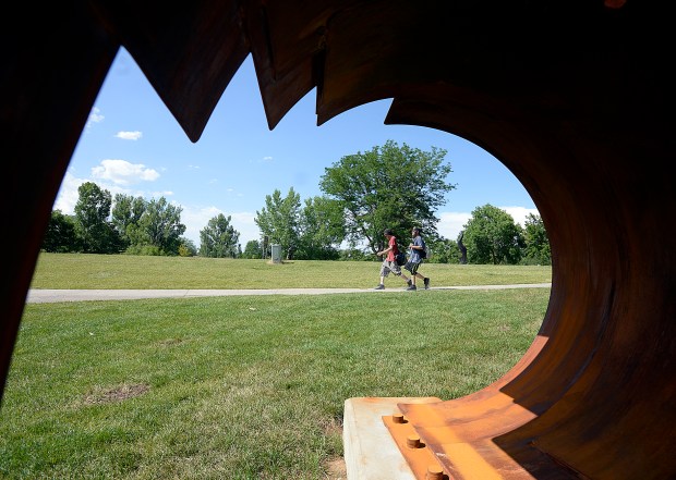 Paul Bishop, left, and Michael D'Ambrosio are framed by a steel sculpture 