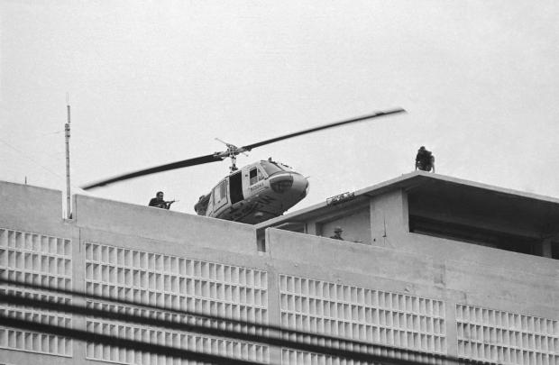 FILE- A U.S. Marine helicopter takes off from helipad on top of the American Embassy in Saigon, Vietnam, April 30, 1975. (AP Photo/Phu, File)