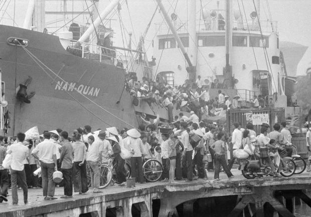 FILE- Last Viet evacuees by boat from Saigon water front in Saigon as PRG troops closing in on April 30, 1975. (AP Photo/Matt Franjola, File)