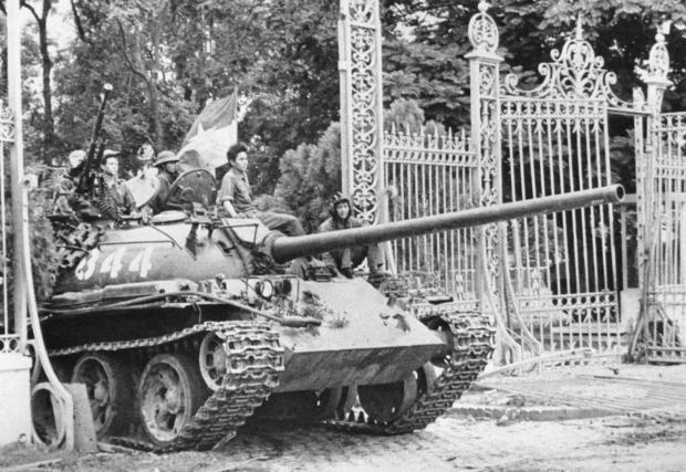 FILE- A Provisional Revolutionary Government (PRG) tank enters the gates of the Presidential Palace in Saigon on May 1, 1975. (AP Photo/Frances Starner, File)