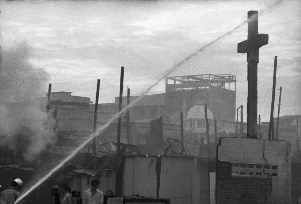 FILE - In this Sunday, April 27, 1975 file photo, a cross from a church in Saigon stands against the dawn sky after a rocket attack and ensuing fire. (AP Photo/Matt Franjola, File)